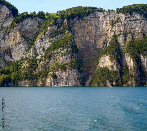 Boats in front of the steep cliffs on Lake Lucerne near Seelingberg in the canton of Uri, Switzerland