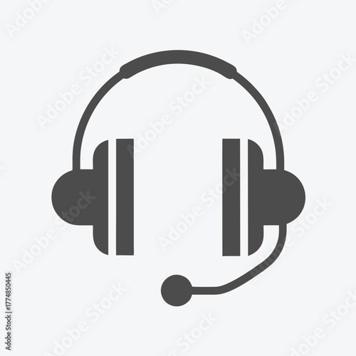 Solid dark gray headset icon with microphone boom stands isolated over a white background