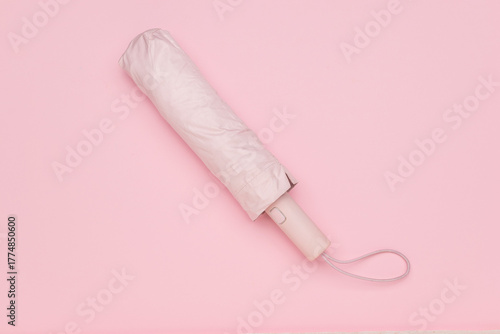 Compact Pink Umbrella on Minimalistic Pastel Background for Modern Lifestyle
