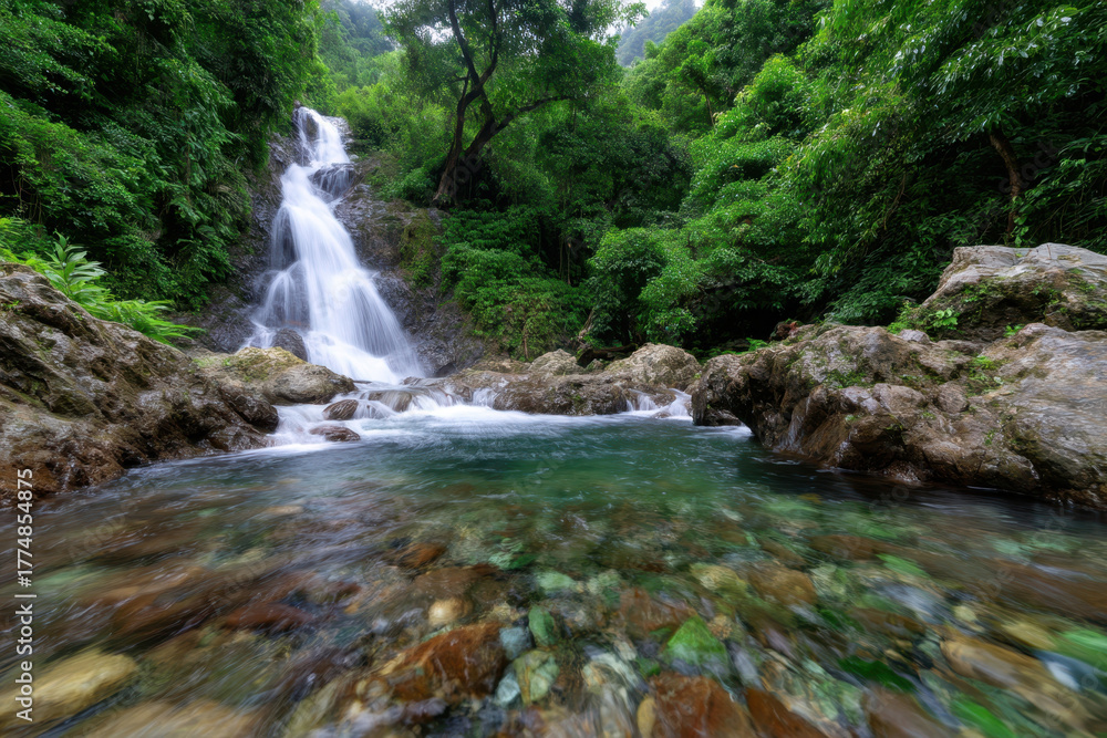 Fototapeta premium Waterfall cascading through lush greenery in a serene natural landscape