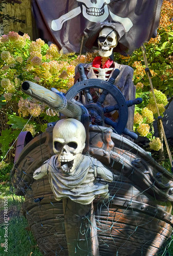 Halloween pirate ship with ghosts and wheel.