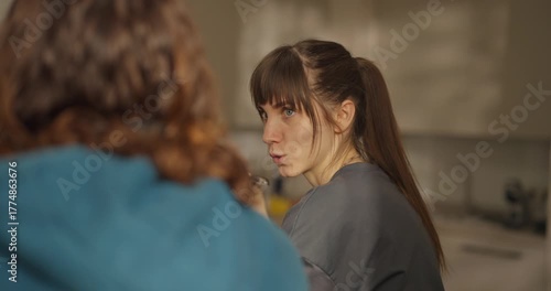 Two friends share a quiet moment in a softly lit living room, exploring thoughts and emotions in deep conversation