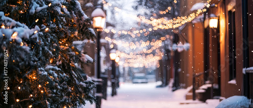 Winter street decorated with garlands and Christmas trees glowing under lanterns. Peaceful evening city atmosphere before the holiday.