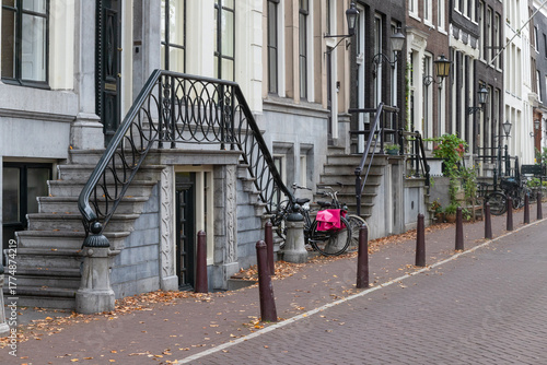 External stairs and raised entrances to canal houses in Amsterdam's old city center.