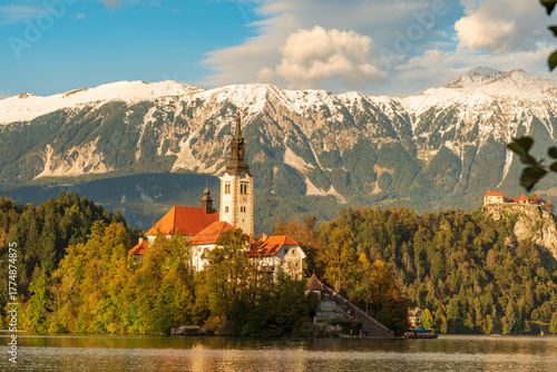 Photos Peaceful sunset view of Lake Bled with the island church and castle reflecting i