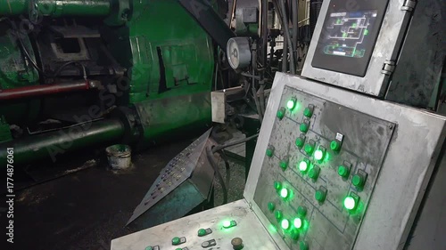 Control Panel of Hydraulic Press with Blinking Green Indicators in Gloomy Industrial Workshop