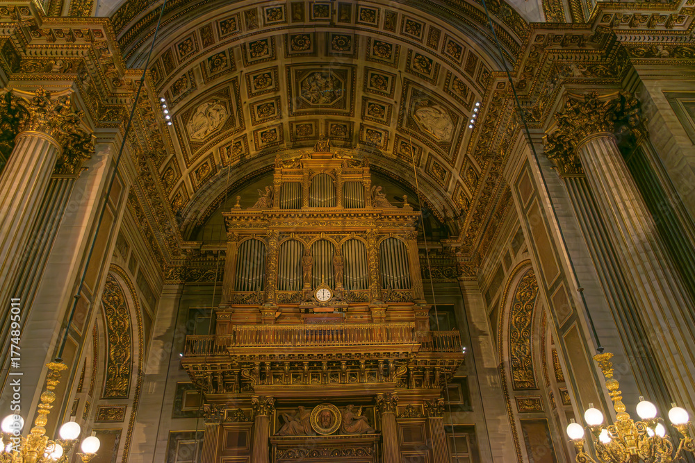 Fototapeta premium Grand organ of the Madeleine Church in Paris, built by Aristide Cavaille-Coll in 1846, featuring gilded Neoclassical architecture