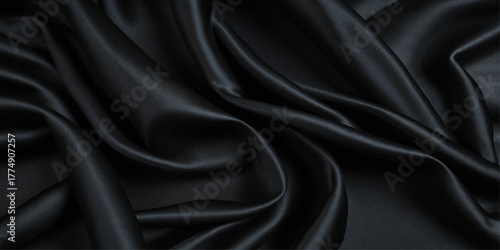 Luxurious black smooth silk or satin texture background. Black silk wave and curve background.	