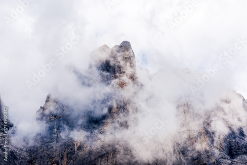 Misty Alpine Mountain Peak Emerging Through Clouds.  Leukerbad, Valais, Switzerland.