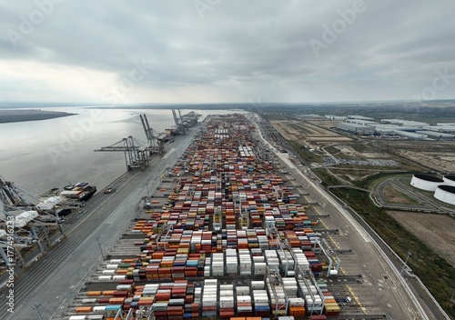 Photography Aerial drone shot wide angle photo of busy shipping port, with gantry trains, ca