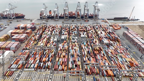 Fotografie Aerial drone shot of large cargo ship tanker, gantry cranes and shipping contain