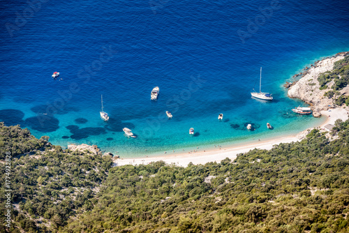 Amazing Lubenice beach, almost only accessible by the sea, with its turquoise waters and sand shore, below steep slopes of Cres island, Croatia
