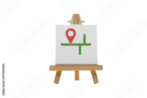 Creative design featuring a location marker and map lines displayed on a small canvas easel