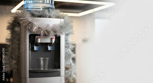 Modern water cooler decorated with festive tinsel, symbolizing holiday spirit and workplace celebrations, perfect for office decoration ideas and seasonal promotions.  