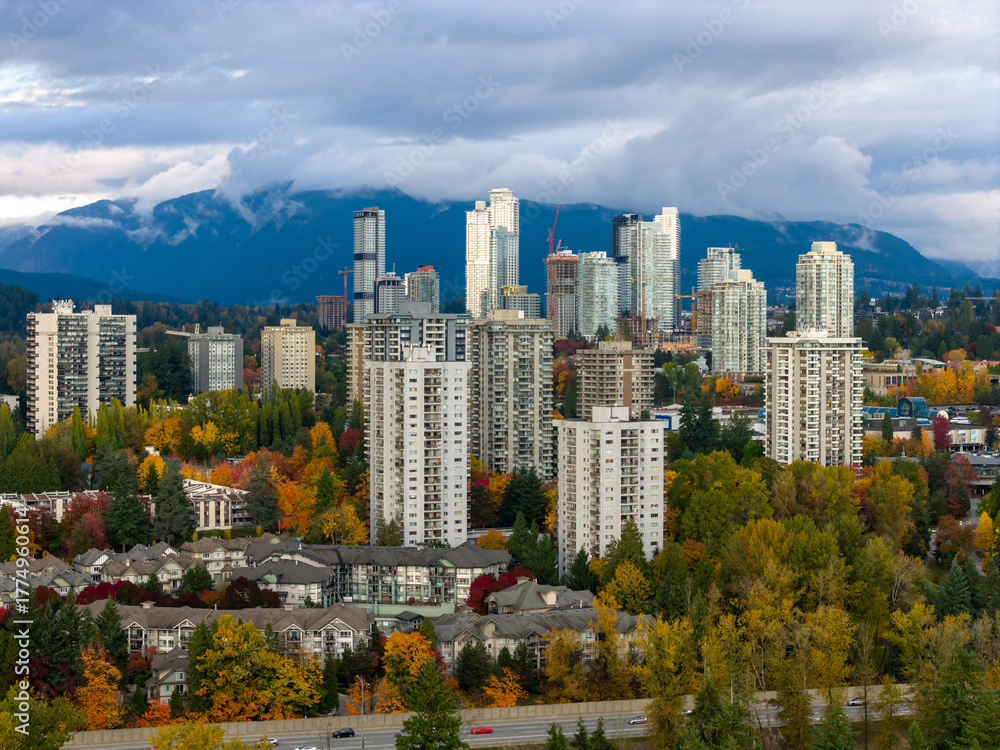 Fototapeta premium Autumn Cityscape Of Burnaby High Rise Apartments With Mountain Backdrop In Vancouver BC