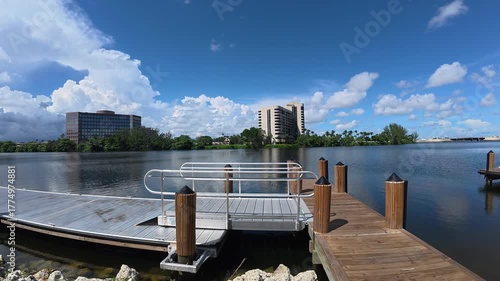 Panning Shot of a River with Small Wooden Pier from the Shore

