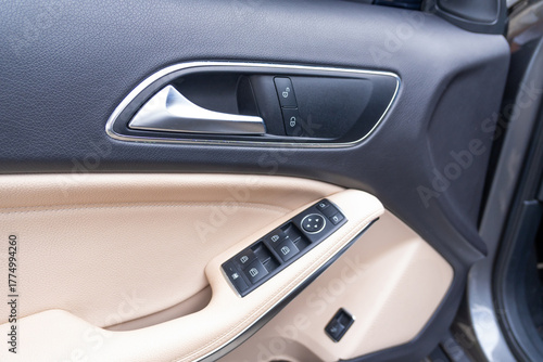 Close-up photograph of the control knob and lock of a modern vehicle door