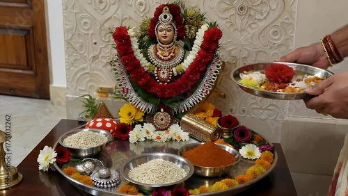 traditional ceremonial platter utilized for devotional rituals  featuring auspicious elements including grains  vermilion powder  and floral