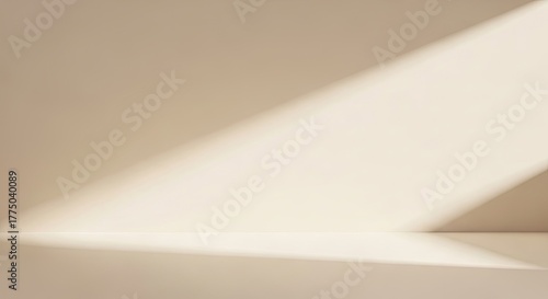 Empty beige studio room with sunlight streaming in.