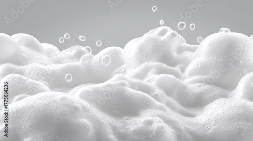 Close-up of white, fluffy foam with bubbles rising, suggesting cleaning or bathing. Soft textures and gentle light