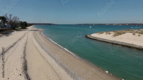 Aerial  Perspective of a Serene and Unoccupied Sandy Shoreline with a Tranquil Body of Water in a Coastal