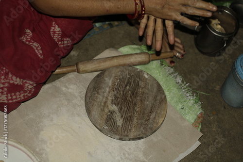 Traditional Indian cooking scene showing a woman shaping chapati dough, representing love, care, and the everyday rhythm of rural and urban Indian life.