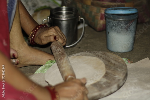 Traditional Indian cooking scene showing a woman shaping chapati dough, representing love, care, and the everyday rhythm of rural and urban Indian life.