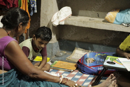Child learning at night under low light with open books and school bag nearby, capturing the essence of dedication, poverty, and the pursuit of education in everyday life.