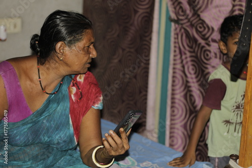 Portrait of an Indian grandmother enjoying a mobile video call, showcasing emotional warmth, happiness, and the modern blend of tradition and technology.