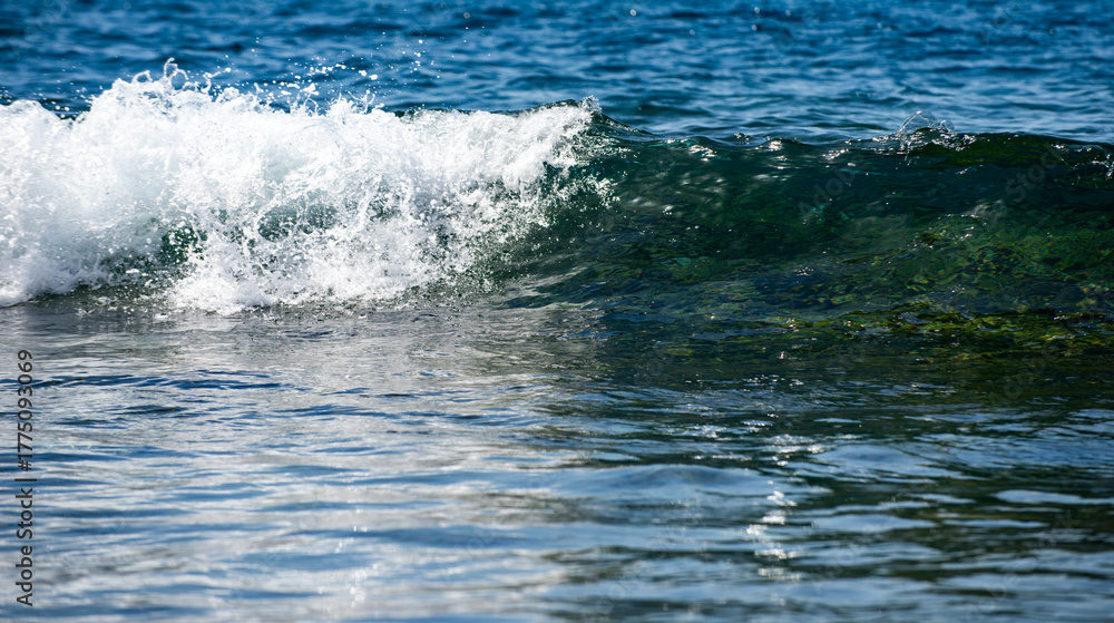 Fototapeta premium Rolling sea waves movement. Wave background. Soft sea waves. Blue sea waves reflect sunlight. Abstract ocean texture.