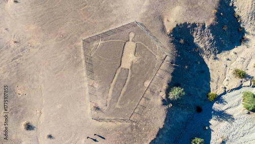Blythe Intaglios Aerial View – Main Human Geoglyph, California Desert. Ancient desert figure near Blythe with visible erosion channel approaching fence, showing natural wear over time.