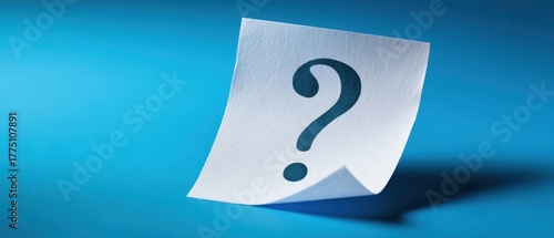 The Question Mark on a Curled White Note Against Blue Background