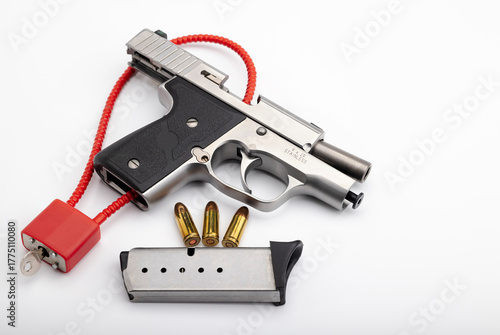 9 mm.Bullets  with Locked disarmed and secured automatic hand gun on white background , Gun safety concept