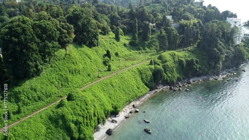 Beach skyline panorama, Amazing mountain path over coastline, Beautiful seashore with boats and green plants, Aerial perspective of rugged mountains meeting calm sea