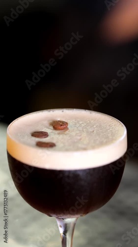 Espresso martini coupe with glossy crema, precise placement of coffee beans using tweezers, dark backdrop and soft bar light, rich caffeinated cocktail for night tasting