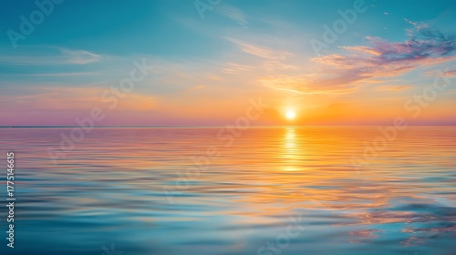 Calm sea at sunset with orange and blue colors reflecting in the water