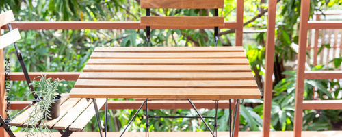 Empty Wooden Garden Table with Hanging Plant, Outdoor Dining Space