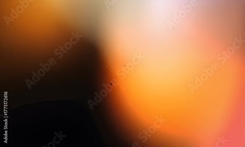 Abstract textured background with a gradient of soft red and orange hues creating a warm and inviting atmosphere with a subtle bokeh effect