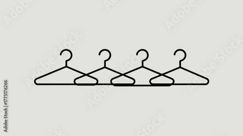 Four wire clothes hangers arranged in a row on a neutral background