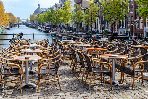 Outdoor dining area along scenic canal in Amsterdam