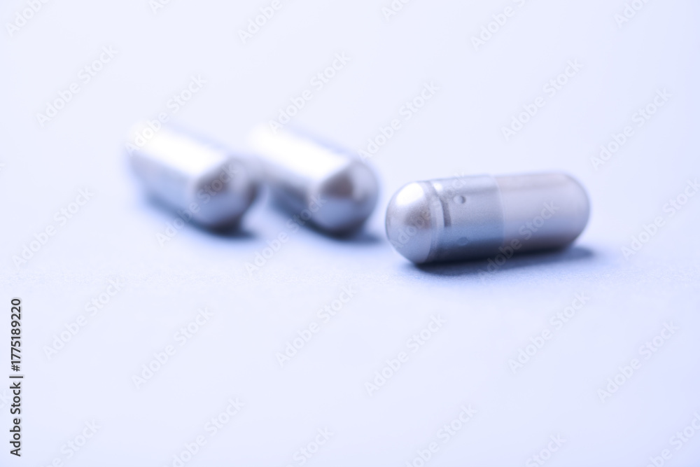 Fototapeta premium BCAA amino acids tablets. Nutrition for bodybuilding. Fitness supplements on bright background. Soft focus. Copy space. 