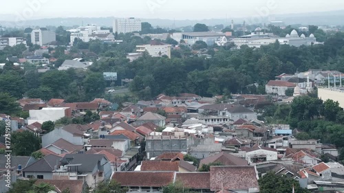 Aerial footage of densely packed rooftops in Indonesian urban neighborhood
