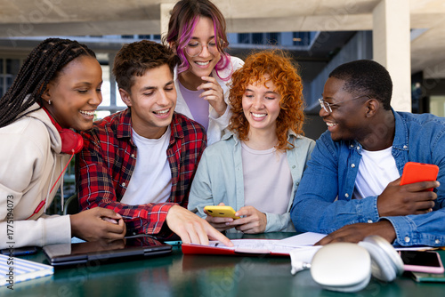 Group of cheerful diverse students working together on a project at university campus