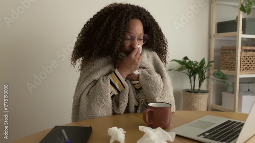 Sick african american woman working remotely from home