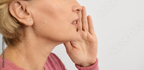 Woman calls the interlocutor by putting her hand to her mouth to amplify the sound. Social problem of deafness in people