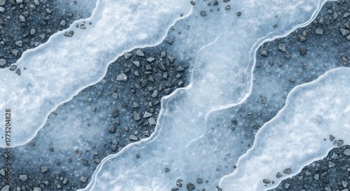 An aerial shot reveals a ground layer of ice over dark stones in a streamlike pattern