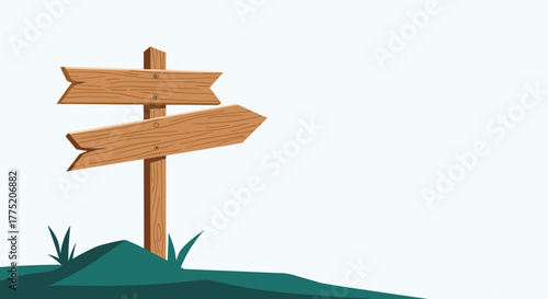 Wooden directional signpost pointing left and right on a grassy hill with a pale blue sky background.