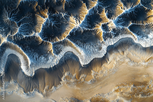 Fototapeta Naklejka Na Ścianę i Meble -  Aerial view of endless sand dunes forming mesmerizing patterns