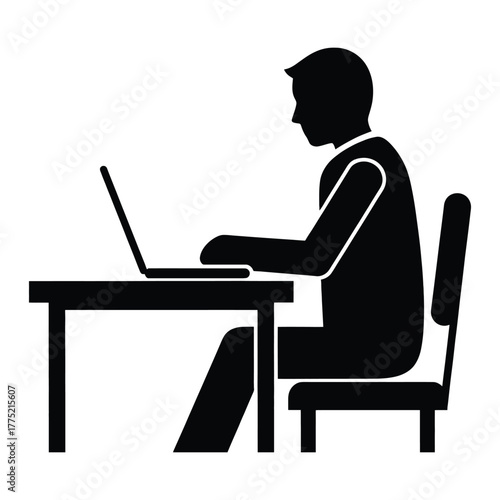 Silhouette of a person working at a desk with a laptop