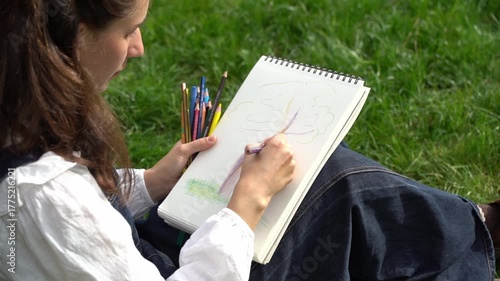 Girl Drawing in Summer Park. Relax lifestyle portrait 